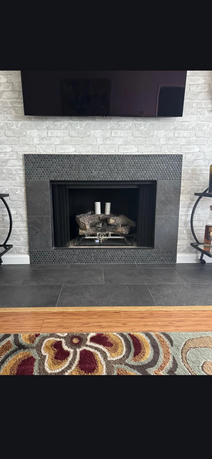 Gas fireplace remodel with dark surround and hearth Gas fireplace remodel with dark surround and hearth