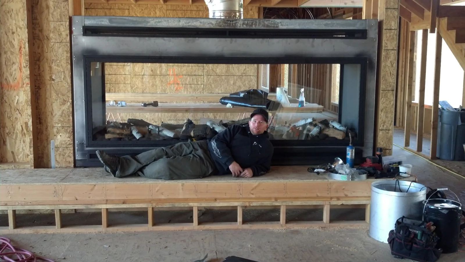 Large linear fireplace installation during construction Large linear fireplace installation during construction