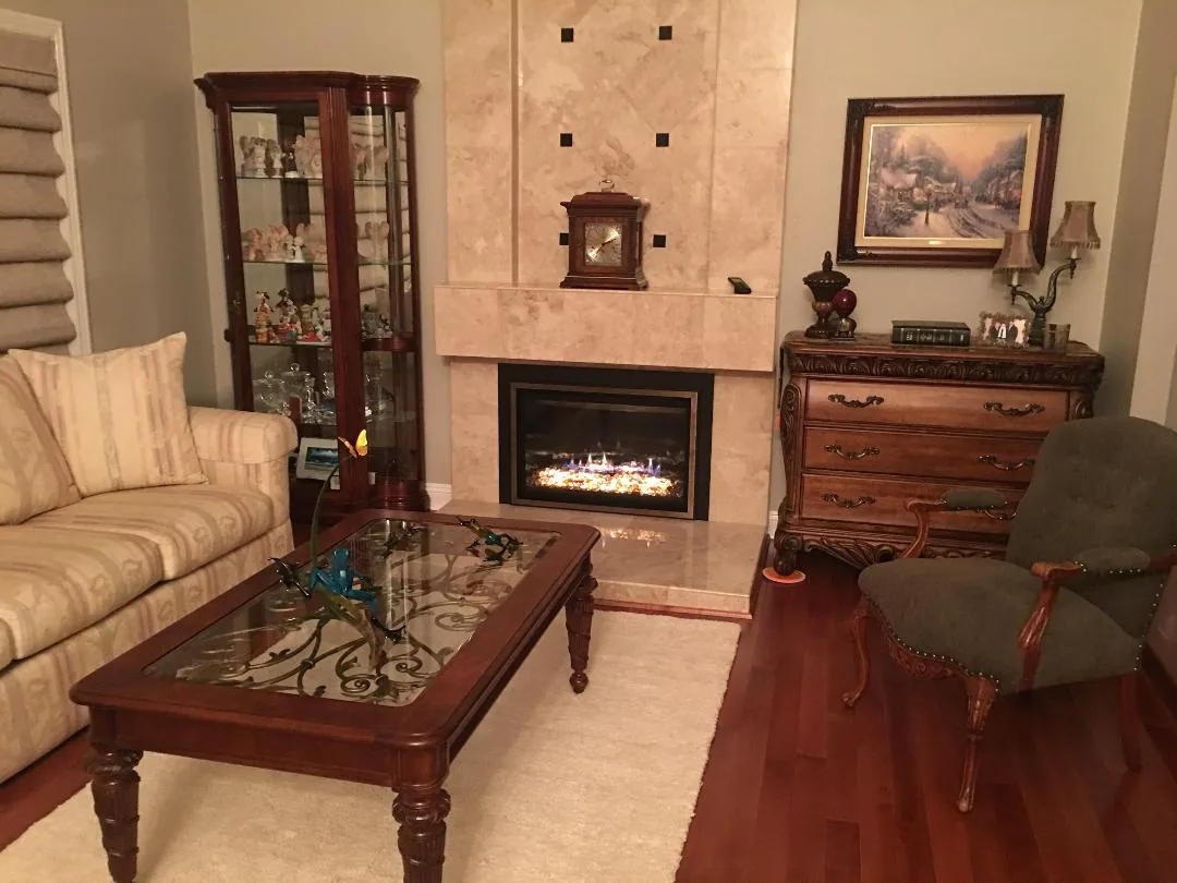 Traditional gas fireplace installed in a furnished living room Traditional gas fireplace installed in a furnished living room